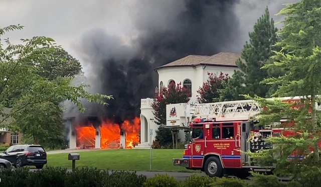 The three-car garage was fully engulfed in flames when firefighters arrived at the house just before 7 p.m. The fire started inside a running car in the garage. SUBMITTED PHOTO